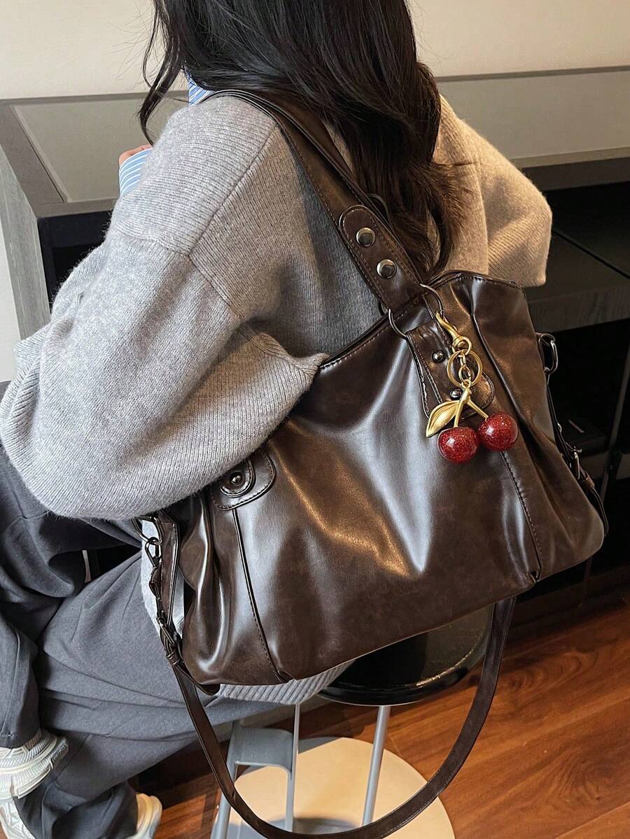 This Classic And Fashionable New Multi-Functional Solid Color Shoulder Bag Is Designed With A Large Capacity Vintage PU Material, Decorated With A Cherry Pendant, And Equipped With A Zipper, Making It