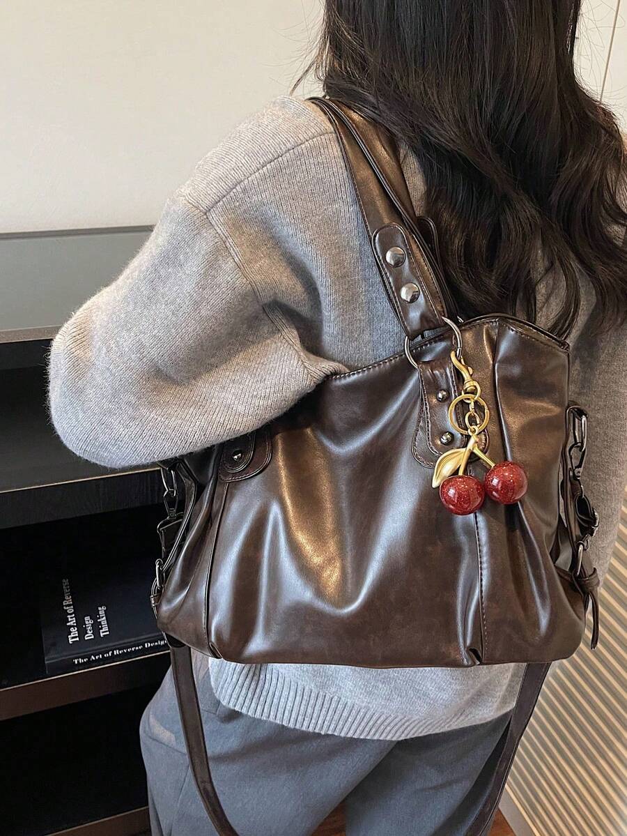 This Classic And Fashionable New Multi-Functional Solid Color Shoulder Bag Is Designed With A Large Capacity Vintage PU Material, Decorated With A Cherry Pendant, And Equipped With A Zipper, Making It