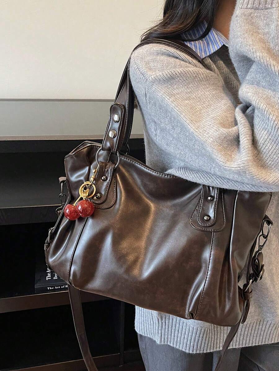 This Classic And Fashionable New Multi-Functional Solid Color Shoulder Bag Is Designed With A Large Capacity Vintage PU Material, Decorated With A Cherry Pendant, And Equipped With A Zipper, Making It