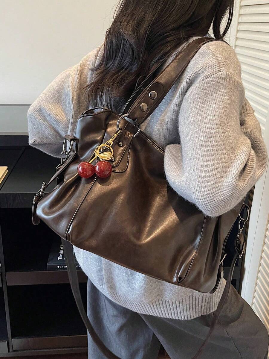This Classic And Fashionable New Multi-Functional Solid Color Shoulder Bag Is Designed With A Large Capacity Vintage PU Material, Decorated With A Cherry Pendant, And Equipped With A Zipper, Making It