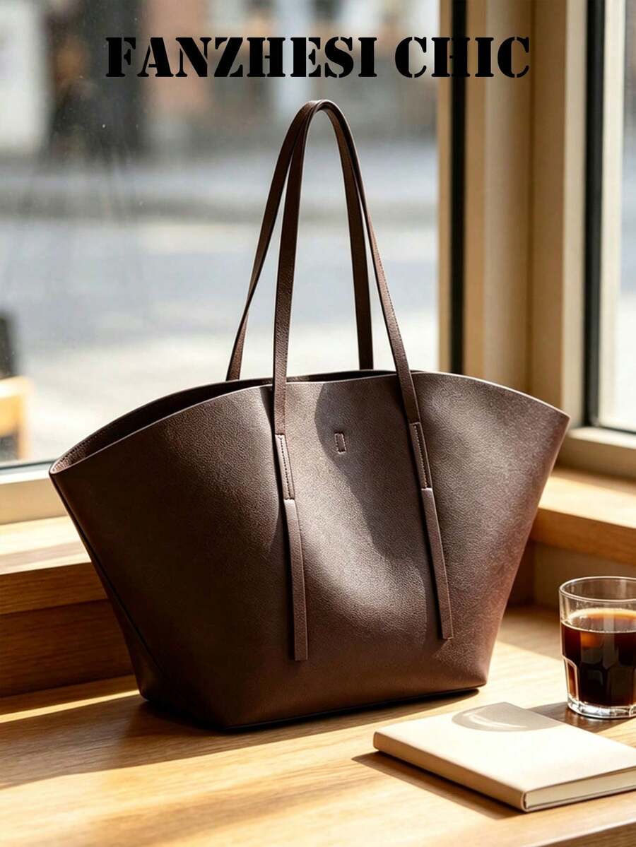 Distinctive Fan-Shaped Large Tote Bag With Wide Flared Silhouette, Reinforced Stitching At Shoulder Strap Attachment, Minimalist Embossed Logo On Front, Slim Shoulder Strap For Shoulder Carry, Open To