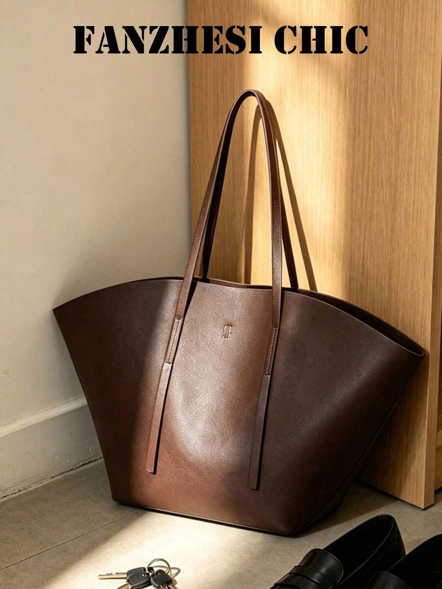 Distinctive Fan-Shaped Large Tote Bag With Wide Flared Silhouette, Reinforced Stitching At Shoulder Strap Attachment, Minimalist Embossed Logo On Front, Slim Shoulder Strap For Shoulder Carry, Open To