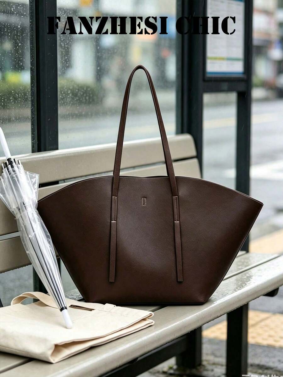 Distinctive Fan-Shaped Large Tote Bag With Wide Flared Silhouette, Reinforced Stitching At Shoulder Strap Attachment, Minimalist Embossed Logo On Front, Slim Shoulder Strap For Shoulder Carry, Open To